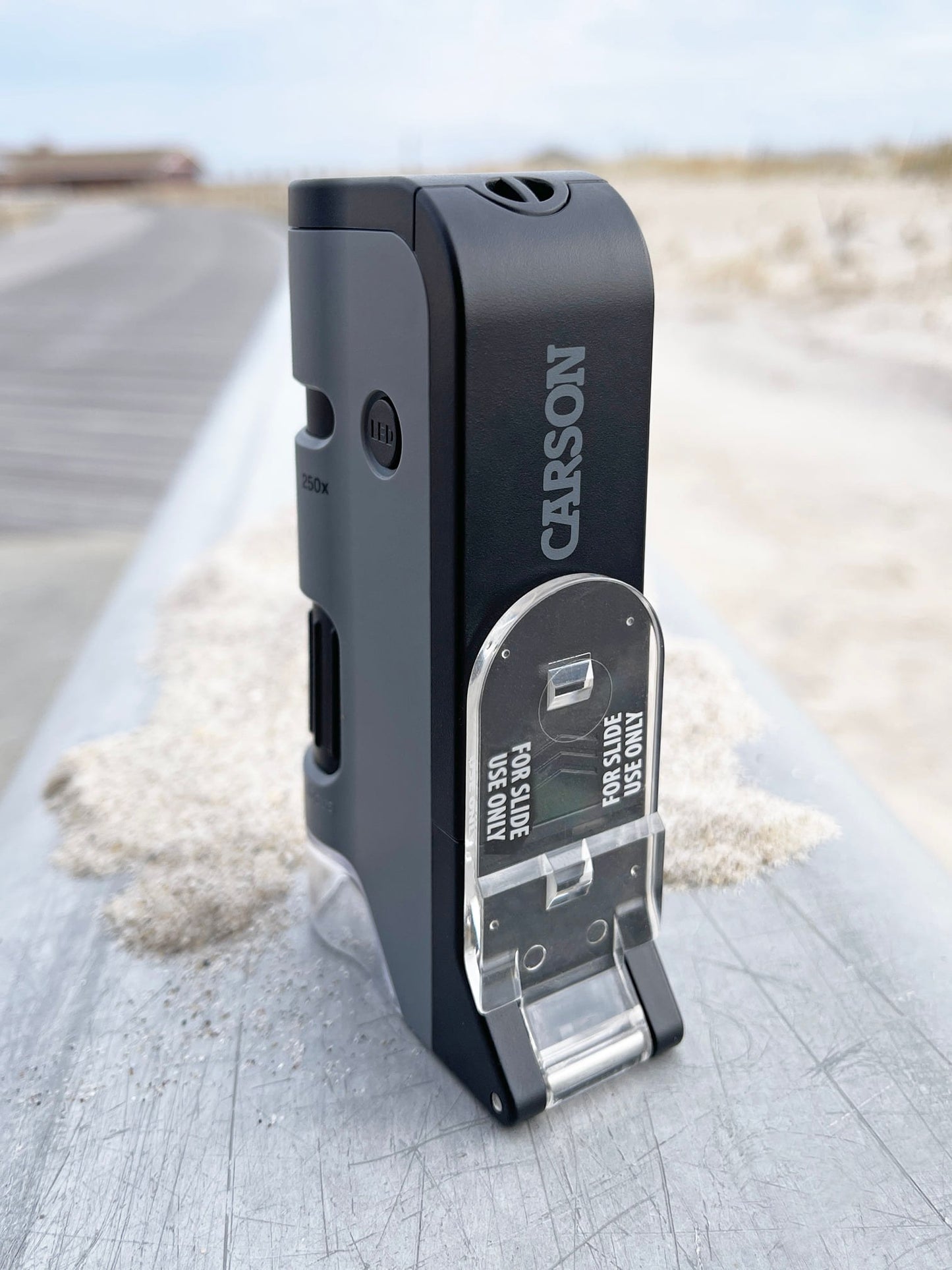 Carson MicroFlip™ 100x-250x LED, UV Lighted Pocket Microscope, Flip Down Slide Base, Smartphone Digiscoping Clip MP-250